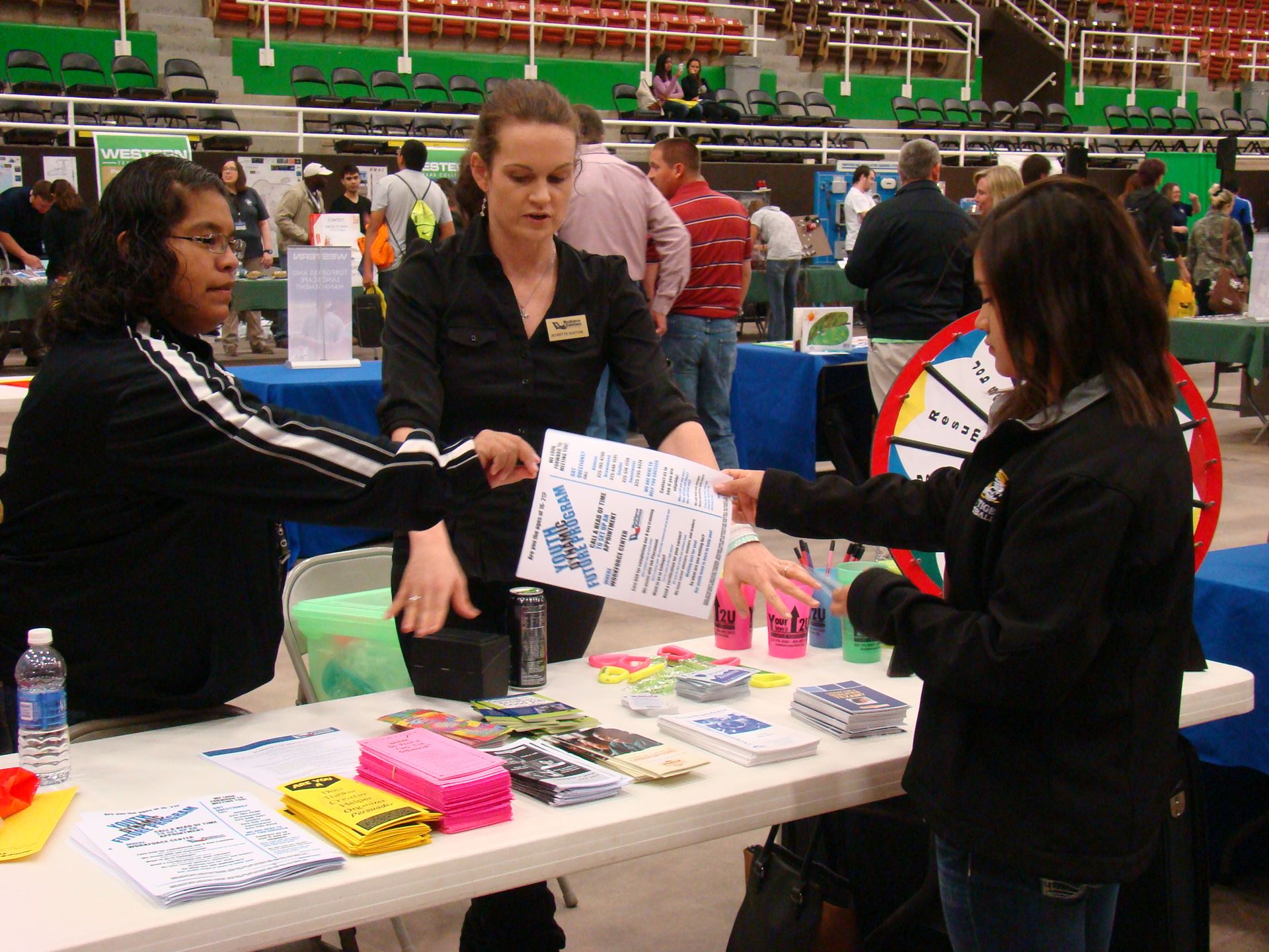 Student talks with workforce solutions staff.